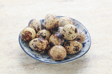 Raw quail eggs heap in the bowl