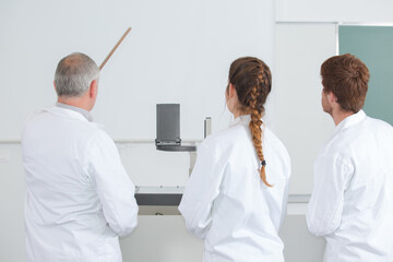 Obraz premium teacher with students in mechanics working