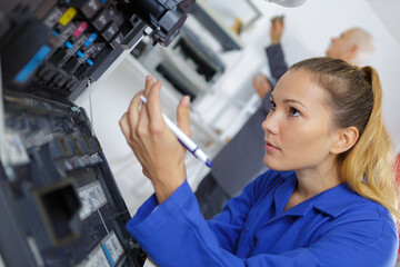 female technician working on photocopier