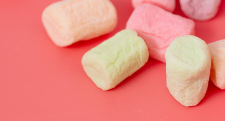 Multicolored candies on a pink background. Close-up