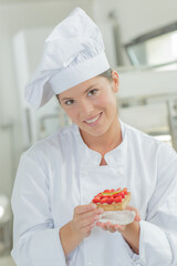 a chef woman holding pastry