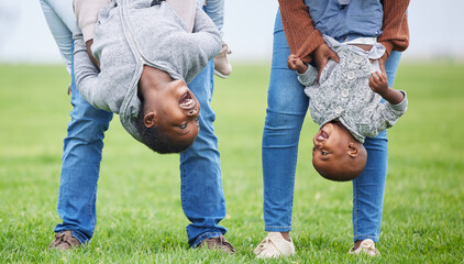 Do anything, but let it produce joy. Shot of two children hanging upside down by their parents...