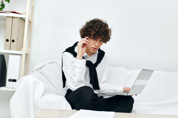 Fototapeta premium teenager laptop sitting on white sofa online training Lifestyle technology