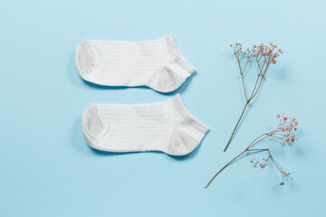 Pair of women socks on blue background.