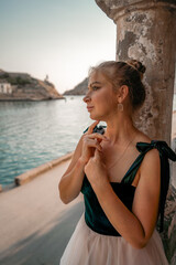 Fototapeta premium Side view portrait of a relaxed woman breathing fresh air at the seaside. She stands near the old column.