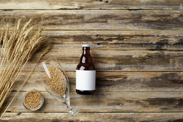 A bottle of beer and grain. Top view. Free space for text.
