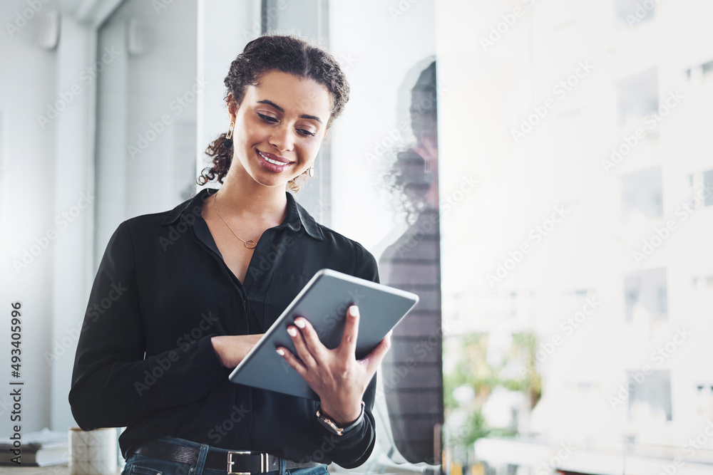 Poster managing her day-to-day tasks with the smartest apps. shot of a young businesswoman using a digital 