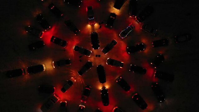 Flash mob cars. Cars are built into a figure and lights are flickering