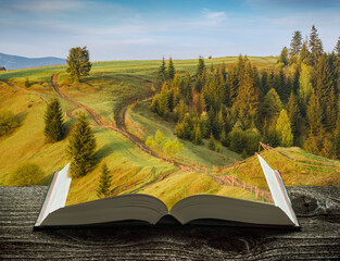 Spring mountain valley on the pages of book