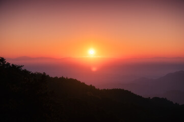 Fototapeta na wymiar Sunrise over mountain with colorful sky in tropical rainforest at national park in the morning