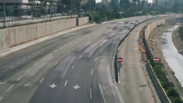 Time lapse of traffic on multi-lane freeway in the middle of city downtown at daytime. Blurred motion. 