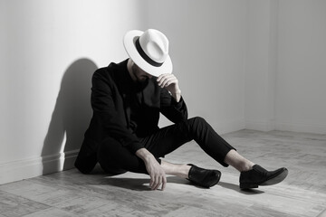 elegant man sitting on floor