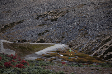 People and tents at camping spot at high altitude 