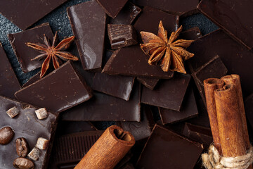 chocolate, cocoa, nuts and spices on wooden background