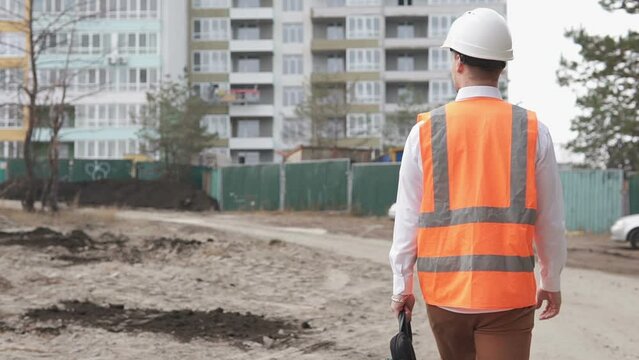 Foreman on the way to the construction site of a high-rise monolithic building.