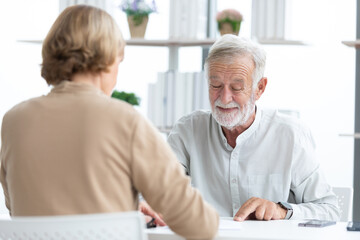 senior businessman or employer asking and talking about works to coworker