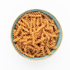 Whole fusilli pasta in a wooden bowl.