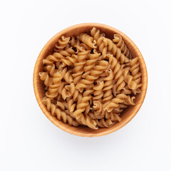 Whole fusilli pasta in a wooden bowl.