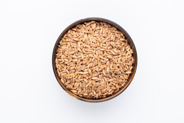 Wheat grains and wooden bowl on white background.