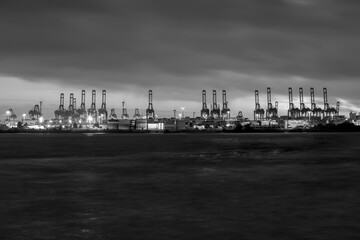 Hamburg Cranes at night, silhouetted against a moody sky