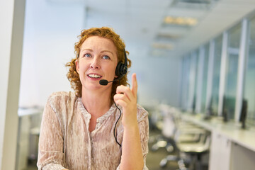 Young businesswoman in the call center in the service hotline