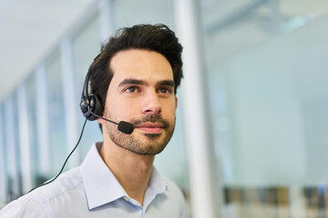 Young businessman as operator in the service hotline