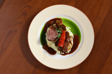 roast beef on puree with pepper and sauce