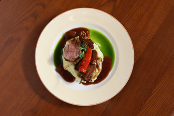 roast beef on puree with pepper and sauce