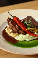 roast beef on puree with pepper and sauce