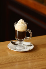 Viennese coffee in a beautiful glass on a plate