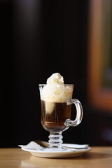 Viennese coffee in a beautiful glass on a plate