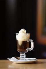 Viennese coffee in a beautiful glass on a plate