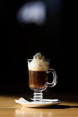 Viennese coffee in a beautiful glass on a plate