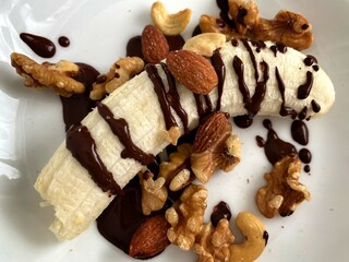Banana with chocolate sauce and mixed nuts