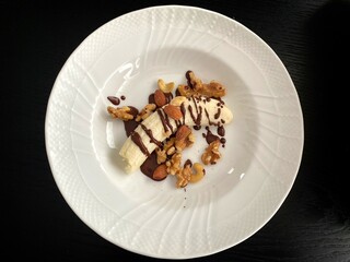Banana with chocolate sauce and mixed nuts