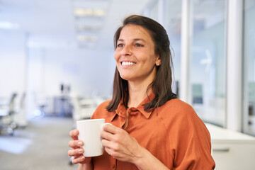 Satisfied businesswoman having coffee during a break