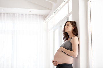 Shes the picture of pregnacy health. Cropped shot of a young pregnant woman standing in her home. - obrazy, fototapety, plakaty