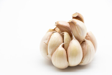 Fresh peeled garlic cloves, bulb with garlic slices isolated on white background.