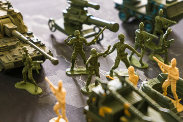 Bangkok, Thailand - March, 16, 2022 : Green toy soldier doll They are waging war on the world map....