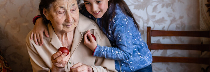 Obraz premium senior woman with easter eggs and Easter cake