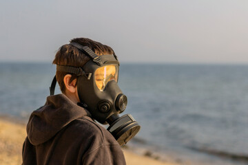 A boy with a gas mask on his face