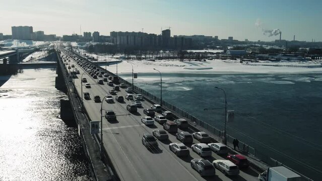 A road bridge against the backdrop of a winter city. Aerial photography of automobile traffic.