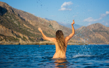 the girl plays happy in the sea water a beautiful summer day