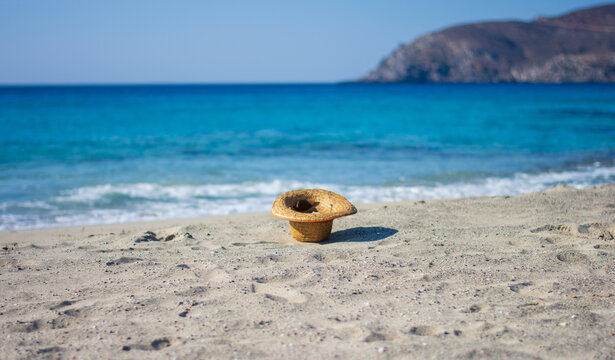 a hat on the beach blown by the wind