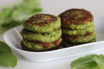 Cottage cheese spinach cutlets. Indian version of cutlets with crumbled cottage cheese, pureed spinach, mashed potatoes and spices. Commonly known as paneer spinach cutlets
