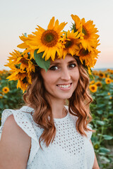young pretty woman in white sundress at sunflowers field