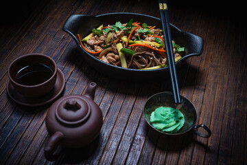Asian style- restaurant background. Udon noodles with beef Wok