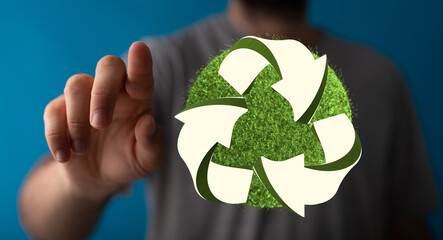 hand holding green recycle symbol