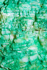 Background from dracocene crystals of stones. Fluorite stone in the rocks of the adit. Mineral stones in their natural environment. Semiprecious stones texture.