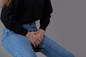 unrecognizable woman with hands holding her crotch from bladder or uti pain. Symptom of cystitis. ealthcare and medical concept.